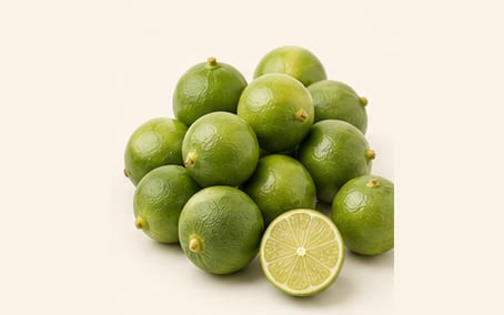 Green Hasawi limes with a cut half
